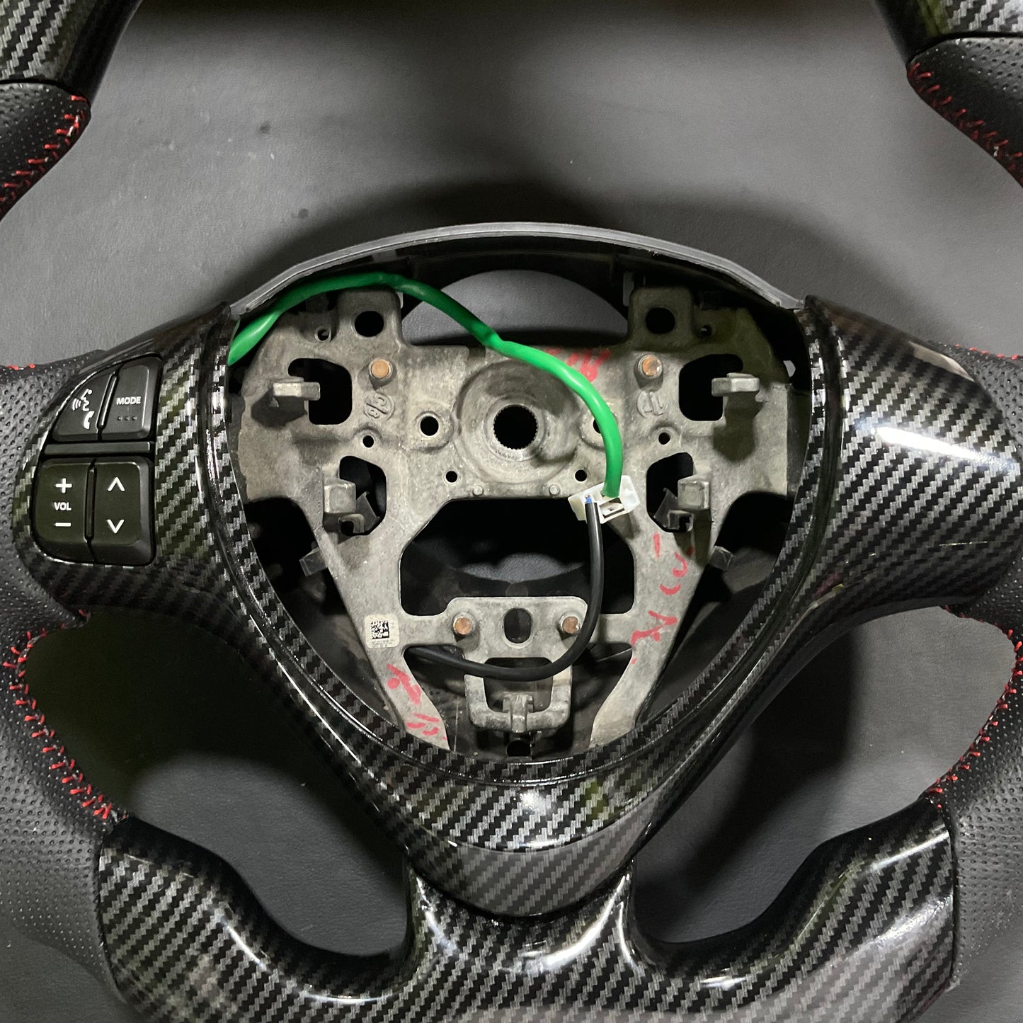 Carbon Fiber Multimedia Steering for Suzuki Alto 2014-2025 with integrated multimedia controls and a sleek, stylish finish.