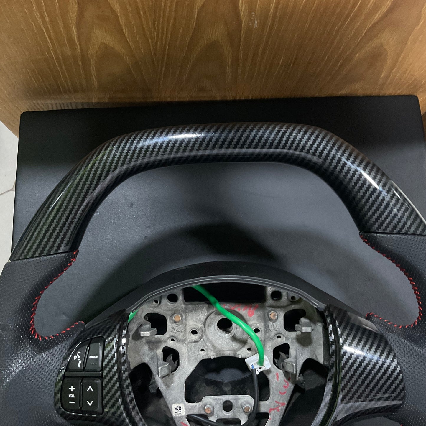 Carbon Fiber Multimedia Steering for Suzuki Alto 2014-2025 with integrated multimedia controls and a sleek, stylish finish.