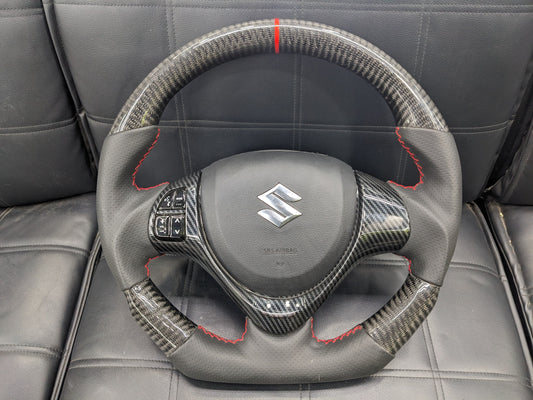 "Carbon Fiber Steering Wheel with Spiral for Suzuki Alto – Premium Grip, Sporty Look, and Durable Design."