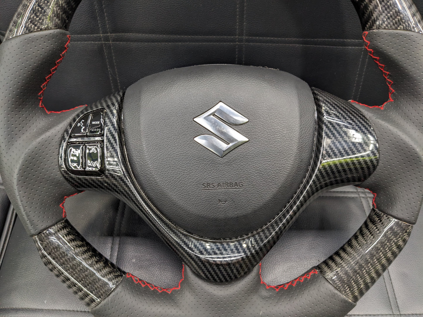 "Carbon Fiber Steering Wheel with Spiral for Suzuki Alto – Premium Grip, Sporty Look, and Durable Design."