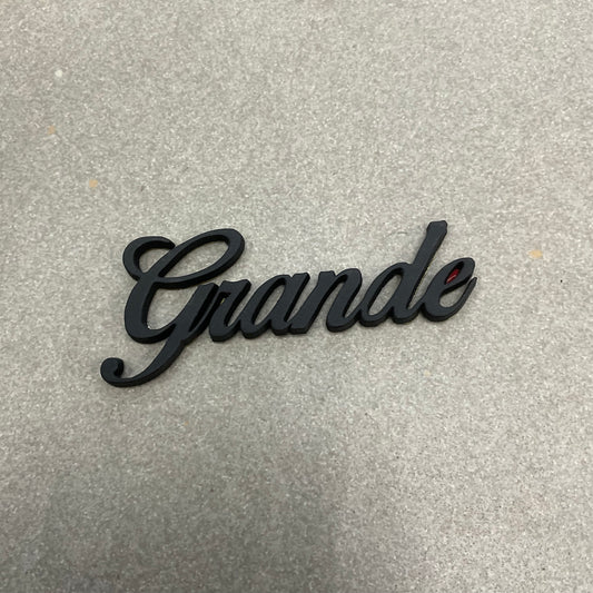 Grande Emblem in Matte Black for Toyota Corolla Rear Trunk, offering a stylish and durable exterior upgrade made from premium ABS material.