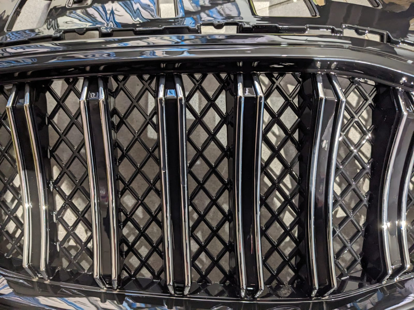 Kia Sportage glossy front grill, designed to add a sleek and premium touch to your vehicle’s front-end appearance.