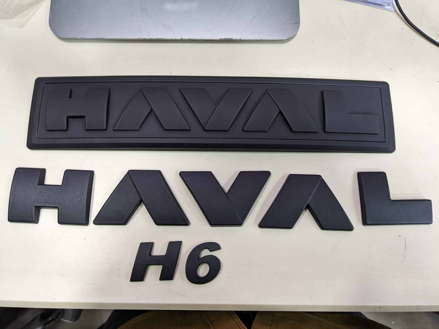 "Matte Black Monogram Emblem for Haval H6 – Front Grille View"