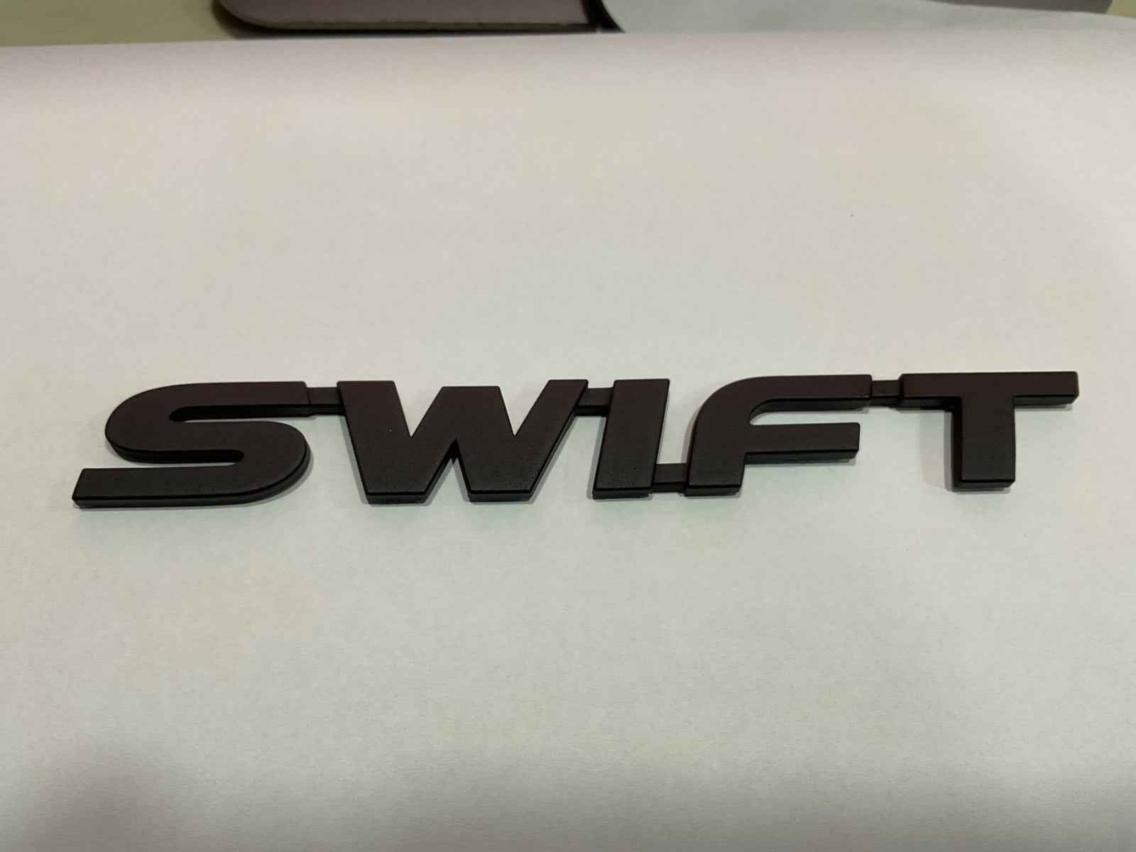 Swift Matte Black Monogram Emblem Logo – Stylish & Durable Car Badge