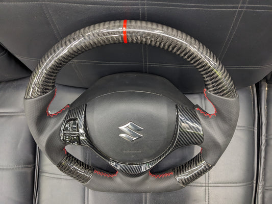 "Carbon Fiber Steering Wheel with Spiral for Suzuki Alto – Premium Grip, Sporty Look, and Durable Design."

