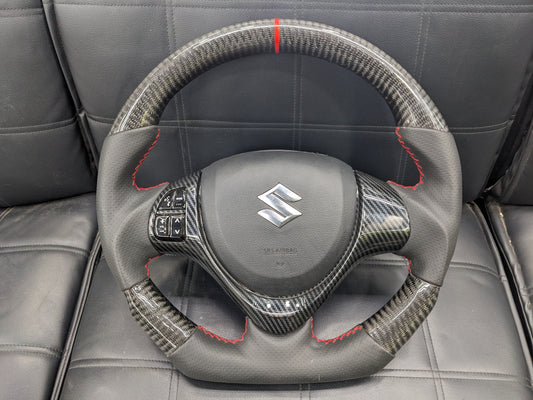 "Carbon Fiber Steering Wheel with Spiral for Suzuki Alto – Premium Grip, Sporty Look, and Durable Design."

