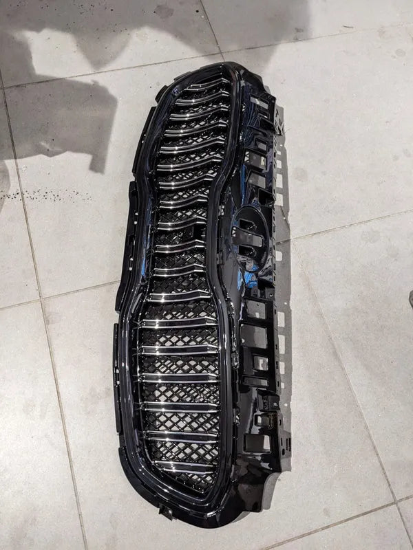 Kia Sportage glossy front grill, designed to add a sleek and premium touch to your vehicle’s front-end appearance.