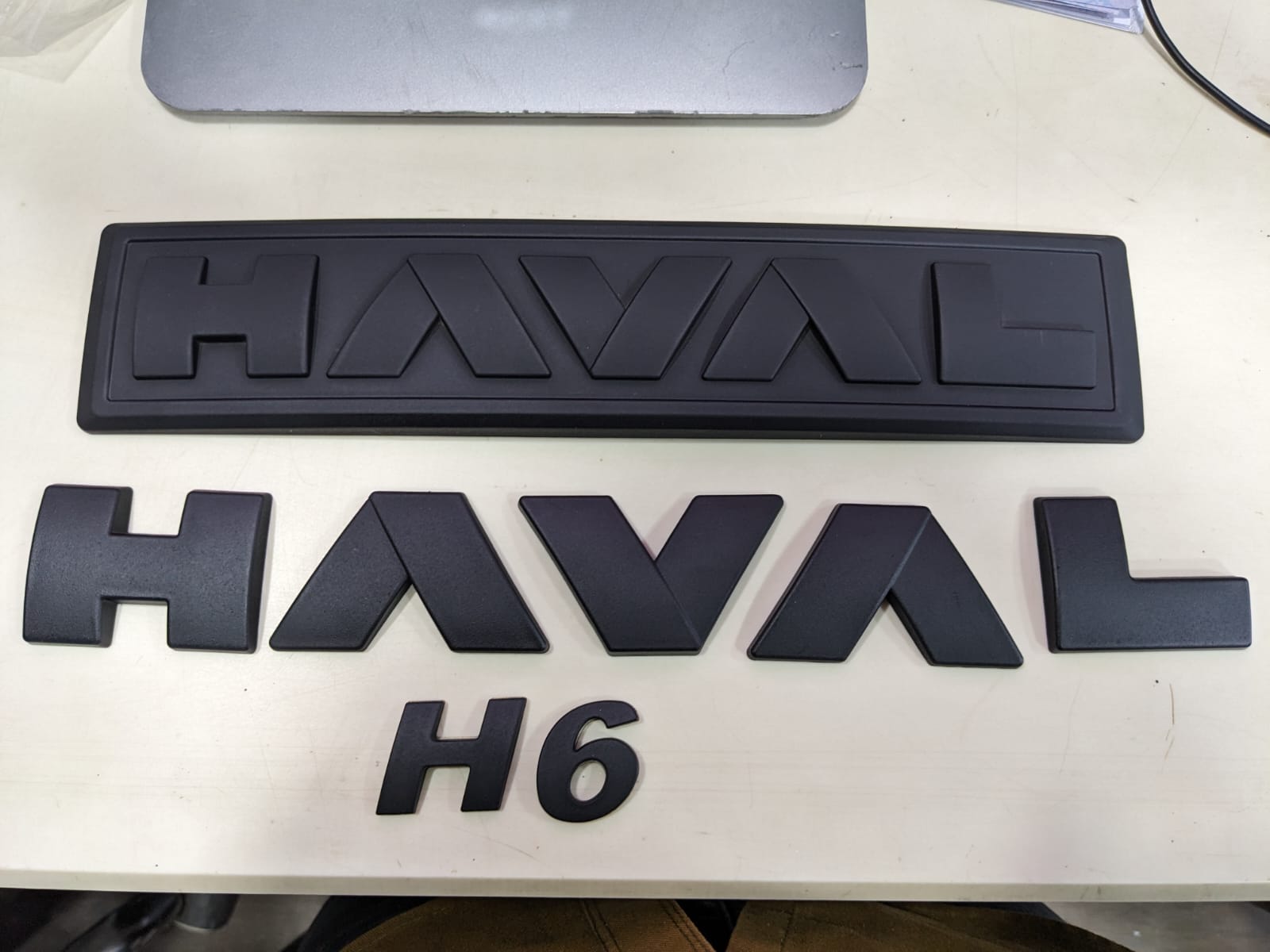 "Matte Black Monogram Emblem for Haval H6 – Front Grille View"
