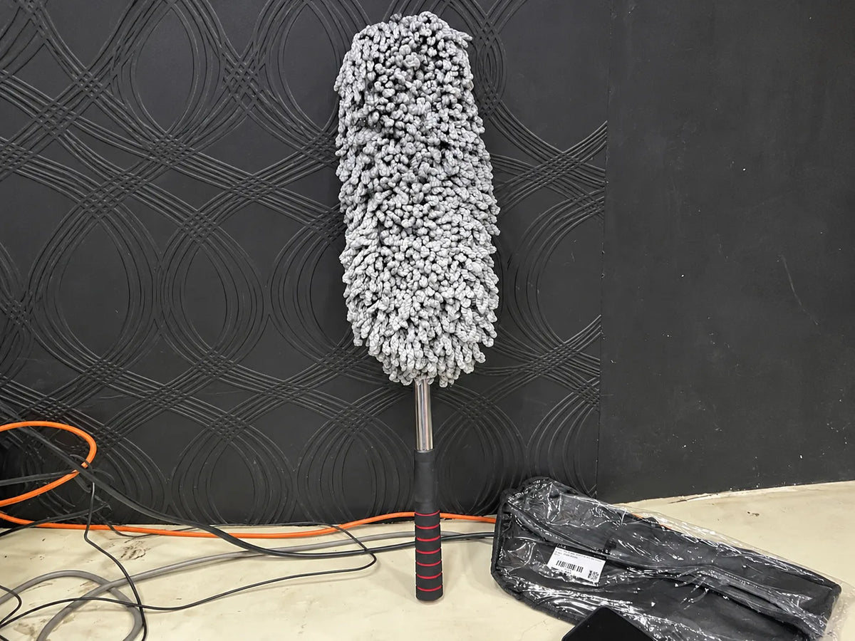 Microfiber car cleaning mop for removing dust from car interior surfaces.