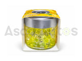 Yellow and transparent gel fragrance beads in a clear air freshener jar with silver lid