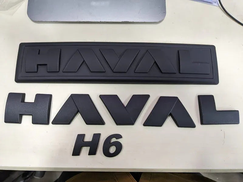 "Matte Black Monogram Emblem for Haval H6 – Front Grille View"
