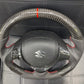 "Carbon Fiber Steering Wheel with Spiral for Suzuki Alto – Premium Grip, Sporty Look, and Durable Design."
