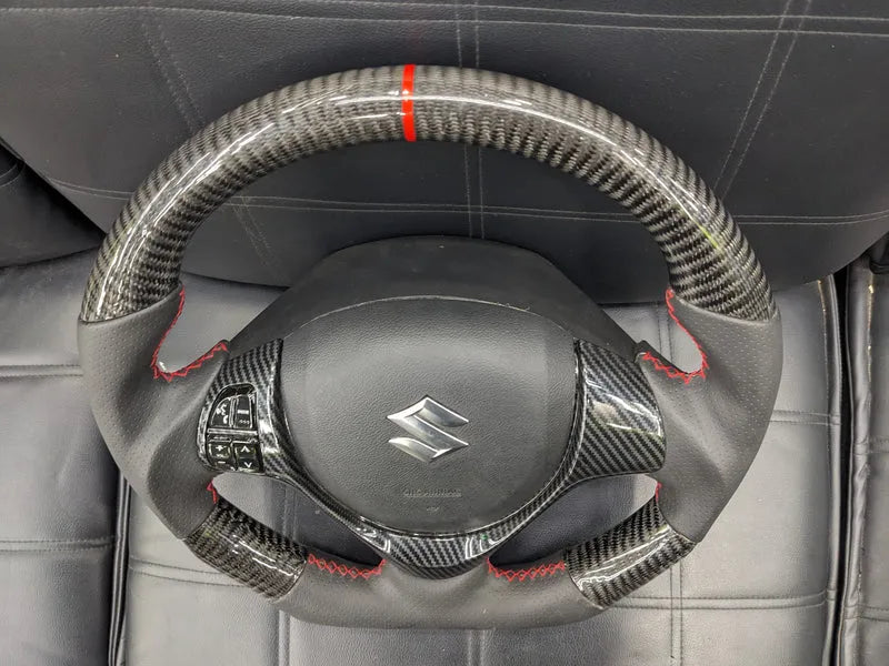 "Carbon Fiber Steering Wheel with Spiral for Suzuki Alto – Premium Grip, Sporty Look, and Durable Design."
