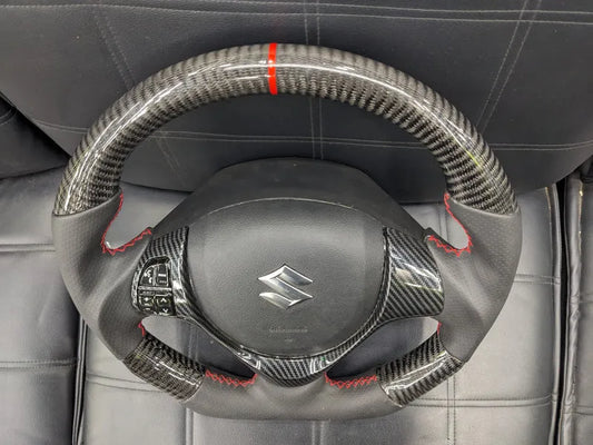 "Carbon Fiber Steering Wheel with Spiral for Suzuki Alto – Premium Grip, Sporty Look, and Durable Design."
